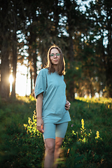 Image showing woman walking early in summer forest area