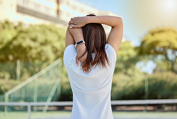 Image showing Tennis, arm and athlete doing a stretching exercise before a match at an outdoor sport court. Fitness, sports and healthy woman doing a warm up workout for a game, training or competition on a field.