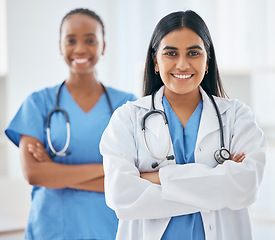 Image showing Happy, portrait and women doctors in collaboration standing with crossed arms in hospital, Happiness, teamwork and leadership of healthcare workers with a smile after success consultation or surgery.