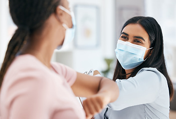 Image showing Covid, elbow bump and employees greeting while wearing face mask in office for teamwork and collaboration. Business women social distancing during covid 19 in a clean, diversity and coworking office