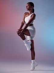 Image showing Black woman fitness, stretching in studio with sportswear or sports fashion in fitness exercise for knee and legs. Girl model, workout clothes in warmup and sport shoes in health training for cardio