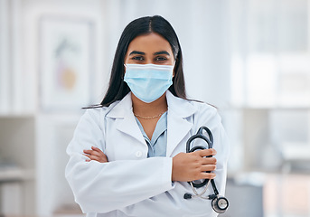 Image showing Covid, medical and arms crossed with portrait of doctor with stethoscope for cardiology, virus and innovation in consulting room. Healthcare, help and medicine with woman in hospital for surgery