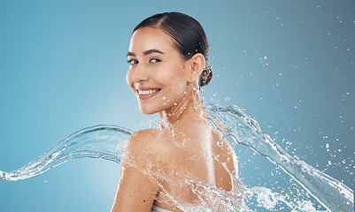 Image showing Beauty woman with water splash and skincare, clean and fresh skin, with body wellness, hydration and health portrait. Model, smile and washing, cosmetics with hygiene in studio background.