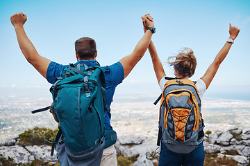 Image showing Success, hiking and couple holding hands on a mountain top in celebration with freedom and support outdoors. Nature, goals and healthy woman enjoys a lovely fitness milestone achievement with partner