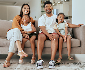 Image showing Portrait, happy family and relax on sofa together in holiday living room at home bonding. Married man, woman smile and young children love cheerful happiness freedom spend time in vacation apartment
