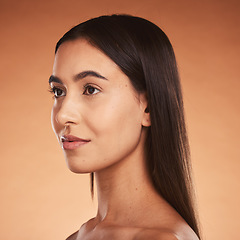 Image showing Woman, silky hair and face beauty wellness lifestyle or luxury skincare. Young aesthetic model, natural cosmetic haircare or makeup, calm facial expression and vision look in orange background studio