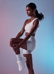 Image showing Woman, fitness and stretching body for exercise, health and wellness against a studio background. Athlete training, warm up and workout for a healthy lifestyle and motivation or strong mindset