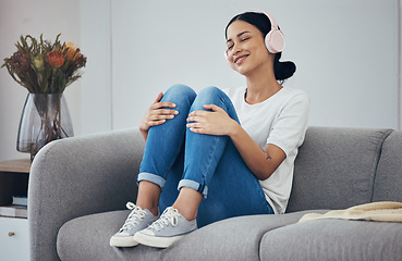 Image showing Relax, headphones and woman on sofa in home living room streaming music, podcast or radio. Happy, smile and carefree female from Canada enjoying listening to audio, playlist or favorite song in house