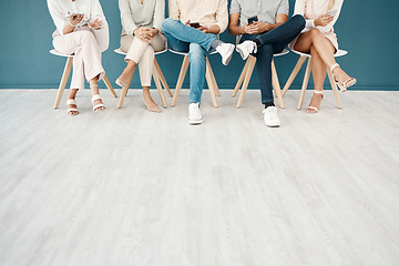 Image showing Feet, team and business people sitting in the office waiting for job interview, presentation and meeting to start. Technology, diversity and group of workers on row of chairs with smartphone in hands