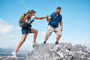 Image showing Helping hand, couple climbing or hiking mountain in nature on vacation, holiday or trip. Freedom, rescue support and traveling man and woman outdoors in countryside rock climbing, exercise or workout