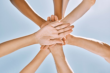 Image showing Below hands stack, group motivation support and trust together outdoor with blue sky. Team hand pile, teamwork vision and solidarity unity friends for community collaboration for people in diversity
