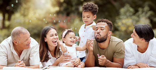 Image showing Happy, smile and big family blowing bubbles in a garden on a summer picnic in Puerto Rico. Happiness, grandparents and parents with children playing, having fun and relaxing together in the park