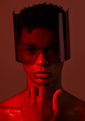 Image showing Red future night, black man portrait and futuristic punk glasses on face against dark background in studio. Cyber model man, plastic visor mask and cyberpunk aesthetic with creative wall backdrop