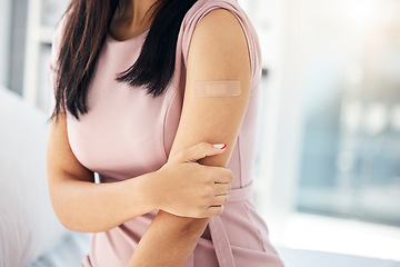 Image showing Covid, vaccine and bandaid on arm of woman in hospital for medical, wellness and medicine. Healthcare, virus and flu injection with girl patient and plaster for first aid, sick or treatment in clinic