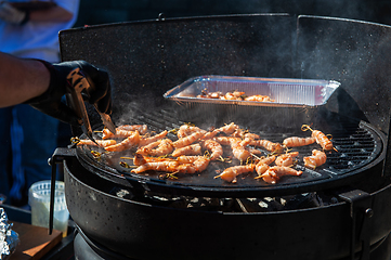 Image showing A professional cook prepares shrimps