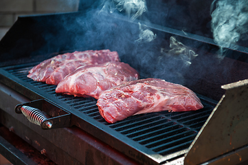 Image showing Pork meat steaks on the grill