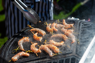 Image showing A professional cook prepares shrimps