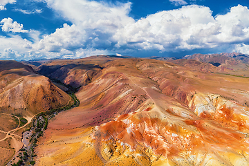 Image showing Aerial shot of the textured yellow nad red mountains resembling the surface of Mars