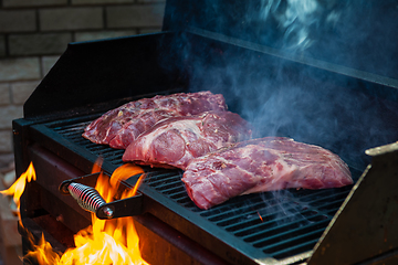 Image showing Pork meat steaks on the grill