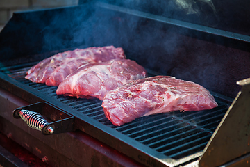 Image showing Pork meat steaks on the grill