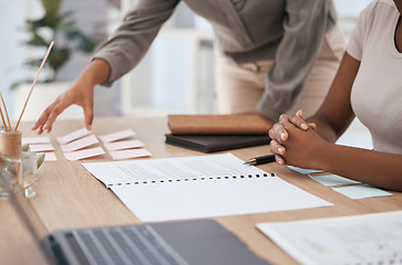 Image showing Hands, meeting and planning with documents, sticky notes and equipment on a desk in an office with a business team at work. Paper, teamwork and strategy with female colleagues working together