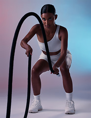 Image showing Girl, fitness and rope training exercise for cardio, muscle and endurance practice with color studio background. Focus, health and power of Indian woman training with gym wellness workout gear.