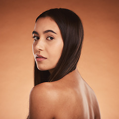 Image showing Beauty, body and haircare portrait of a young woman posing for cosmetic treatment advertisement on studio background. Hairstyle, bodycare and health and wellness care for skin of hispanic female