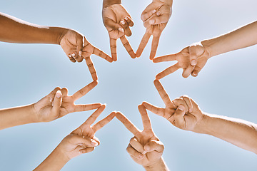 Image showing Hands, star and collaboration with a team of people standing in a huddle or circle with their fingers touching. Sky, teamwork and unity with a man and woman group peace sign in support or partnership