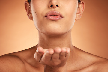 Image showing Skincare, beauty and lips of woman in studio for makeup, grooming and kiss, treatment and lipstick on orange background mockup. Facial, hand and kissing girl model satisfied by product and cosmetics