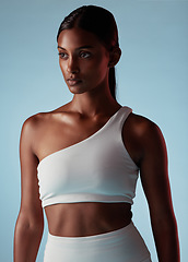 Image showing Fitness, health and sports black woman on studio blue mock up for fashion advertising or marketing. Mission, goal and focus athlete with skin health, glow and exercise wellness lifestyle with mockup