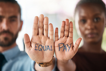 Image showing Hands, equality and empowerment with a business man and woman showing an equal pay notice in their palms. Team, community and collaboration with male and female colleagues standing together in unity