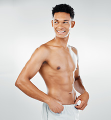 Image showing Skincare, cleaning and man in towel after shower in studio for wellness, beauty and grooming against white background. Skin, bodycare and bathroom hygiene with guy model confident, muscular and happy