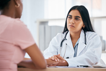 Image showing Support, diagnosis and doctor doing a consultation with a patient in medical clinic or hospital. Test results, bad news and healthcare worker consoling and holding hands with black woman in office.