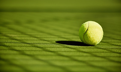 Image showing Tennis, sport and fitness with tennis ball on turf with green closeup and texture, sports match and competition. Training, active and ball on tennis court, outdoor tournament and competitive game.