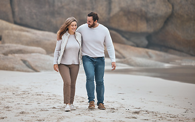 Image showing Happy couple on beach, walking during date and travel, holiday together with love and care outdoor. Love, man and woman smile on romantic walk with sand, happiness and enjoy honeymoon in South Africa