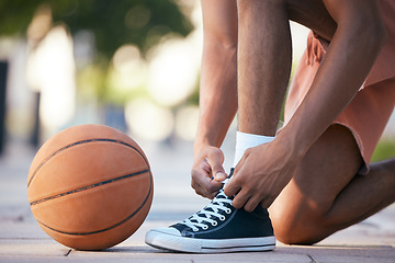 Image showing Hands, shoes and basketball in sports motivation for exercise, workout and exercise in the outdoors. Hand of sport player tying lace for ball game, match or training in healthy cardio fitness outside