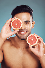 Image showing Skincare, grapefruit and health of man in studio for vitamin c, dermatology and wellness during after facial detox with natural fruit. Portrait of male India model happy about healthcare and skin