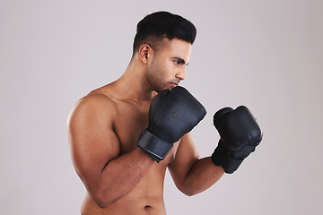 Image showing Fitness, boxing gloves and sports man ready for exercise, training and workout in studio for health, wellness and sport. Male motivation to box, fight and hit for energy, competition and inspiration