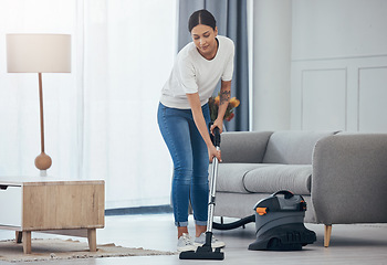 Image showing Woman, vacuum machine and cleaning the floor in the living room in home. Happy latino cleaner doing housework, housekeeper or job in a clean lounge, hotel room or house while alone spring cleaning