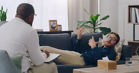 Image showing Man on sofa consulting psychologist in therapy, healthcare clinic and medical office for mental health, depression and stress management. Patient, psychology counseling and therapist problem support