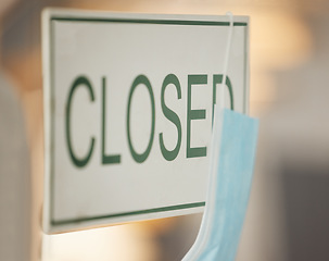 Image showing Covid face mask, closed and door signage on cafe, restaurant or coffee shop glass window in pandemic lockdown. Zoom, texture and small business covid 19 board in government, law or economy compliance