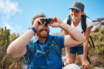 Image showing Hiking, nature and couple with binoculars, happy, smile and relax while watching, looking and explore together. Friends, freedom and hikers bond by woman and man laugh, search and enjoy scenic view