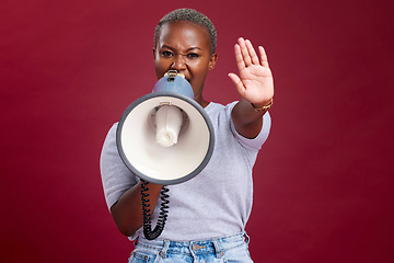 Image showing Black woman, protest and shouting with megaphone for voice, strike or stop against a studio background. Portrait of African female activist with hand gesture, vocal or stand for gender based violence