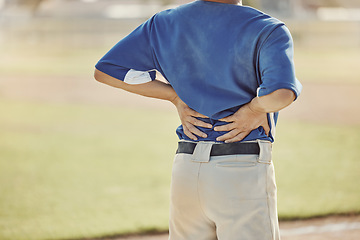 Image showing Sports, baseball injury and man with back pain, emergency or muscle strain during game, competition or fitness match. Softball player, field pitch or back view of athlete with hurt spine or backache