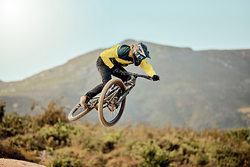 Image showing Mountain bike, man and action air jump and bicycle, challenge and adventure, freedom and fast race in nature. Cycling sports athlete, training and energy on mountain for outdoor speed competition