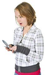 Image showing Teenage girl text messaging on a cell phone