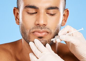 Image showing Beauty, facial and needle with face of man for plastic surgery, aesthetic and skincare. Medical, prp injection and spa with model against blue background for dermatology, treatment or cosmetics filler