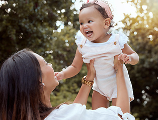 Image showing Park, family and mom holding baby in air enjoying nature, outdoors and sunshine. Affection, love and mother lifting cute toddler girl smiling, bonding and playing together in garden on summer weekend