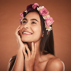 Image showing Flower, crown and woman in beauty studio, skincare and wellness while grooming on orange background. Face, rose and girl model smile, relax and happy with floral product, facial and plant aesthetic