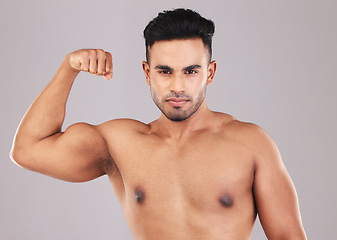 Image showing Fitness, portrait and man flexing his bicep for motivation, energy and power in a studio. Wellness, health and athlete from Mexico with strong arm muscles after training isolated by a gray background